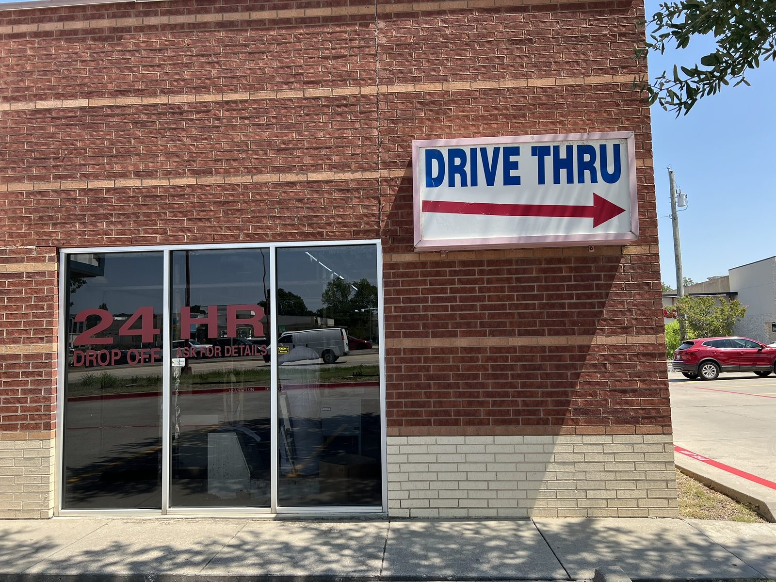 Drive-thru sign and 24-hour drop-off window at Dry Clean Super Center Benbrook